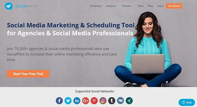 a screenshot homepage of the social pilot media management tool with a background of a woman and a laptop on her lap